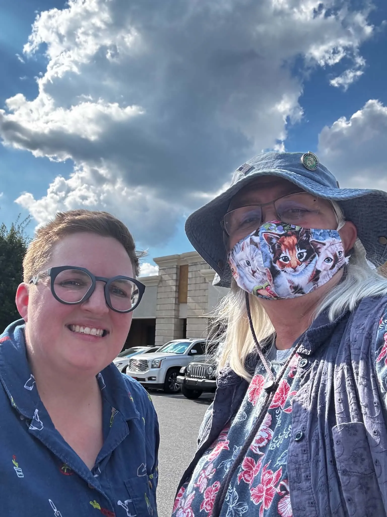 Tammy VanderMolen, on the right, wearing a cat mask and hat.